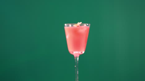 a pink cocktail in a glass against a green screen background, showcasing minimal movement and consistent lighting