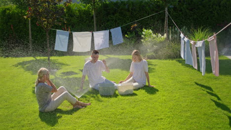 family fun in the garden with a water sprinkler