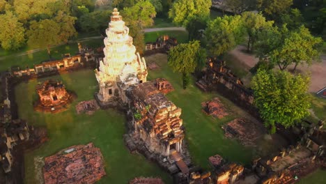 drone footage of ruins of an ancient asian temple in thailand at sunrise