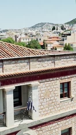 greek flag on a balcony with athens cityscape
