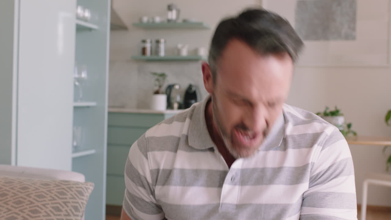 happy man singing at home having fun celebrating successful lifestyle dancing enjoying karaoke music entertainment