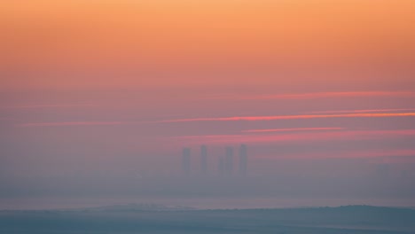 timelapse madrid skyline 5 towers skyscrapers during sunrise in winter foggy and low clouds