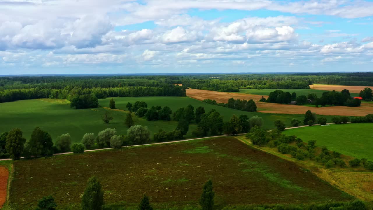 Aerial view presenting diverse rural landscape with farm fields and green forests