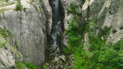 an aerial view of a small waterfall in the french pyrenees mountains