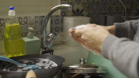 Close-up-of-hands-washing-and-srcubbing-a-dirty-plate