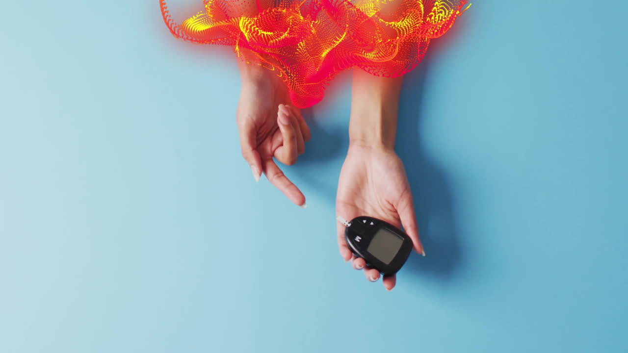 Hand holding glucose meter with colorful abstract animation above on blue background