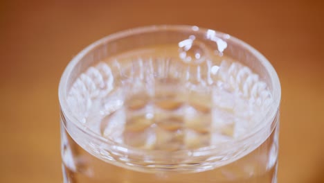 a dynamic close-up of water splashing a glass capturing the essence of refreshment and clarity