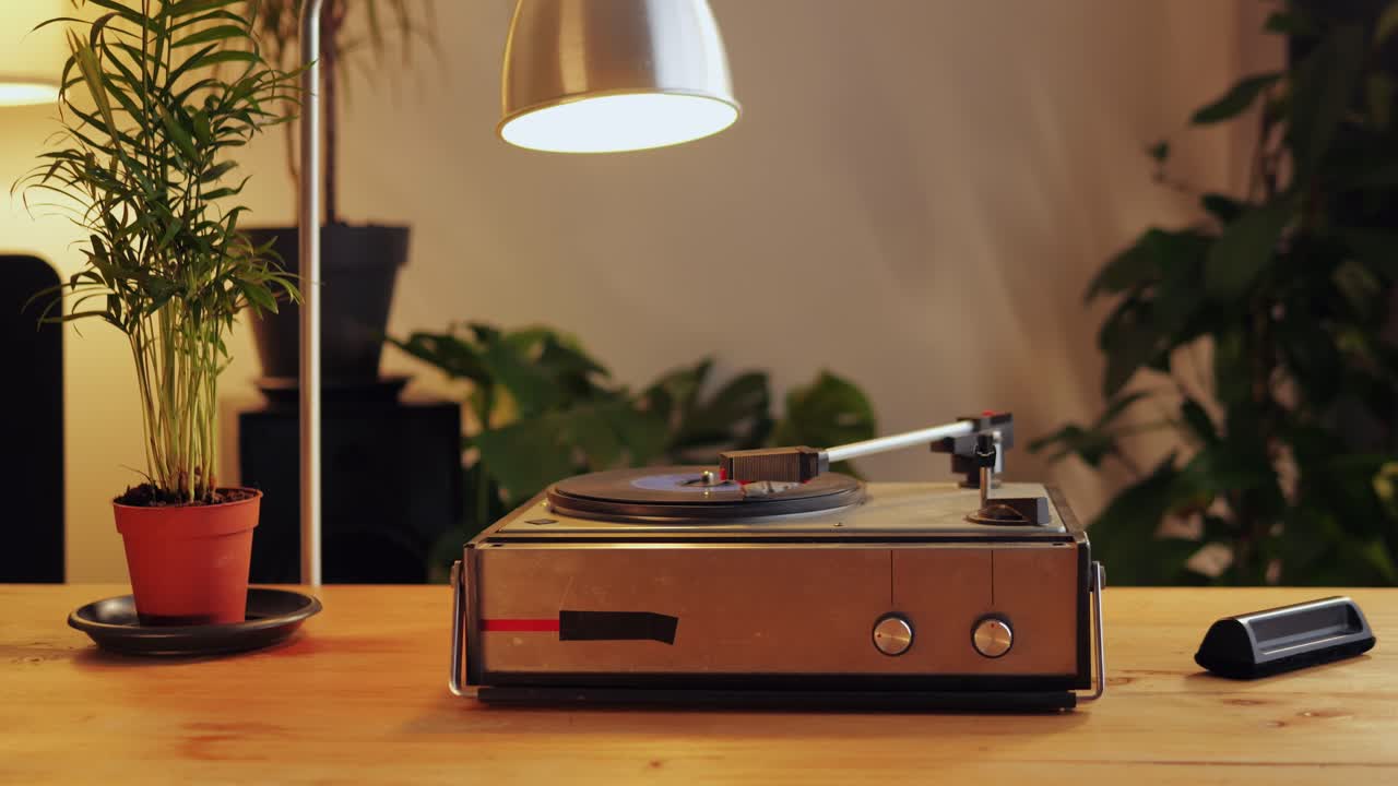 Retro Vinyl record player playing music, close-up macro shot of vintage LP disc old phonograph spinning. Retro music player.