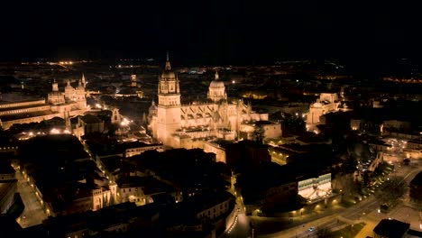 orbit shot at night time of distinctive basilica in heart of salamanca city, spain