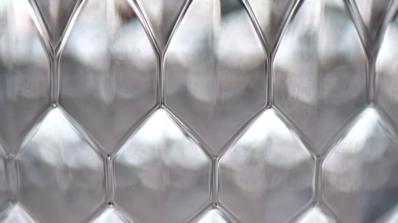 Close-up view of a textured surface with a geometric pattern with a metallic material