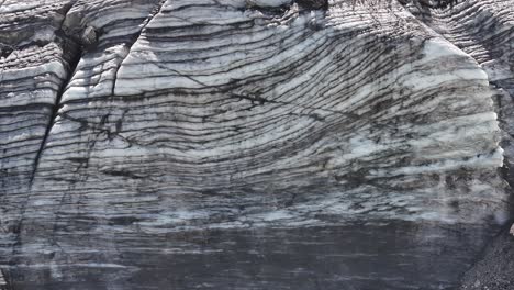 slow lateral pan showing beautiful and abstract stone cliffs near klausen pass, urner-boden, switzerland