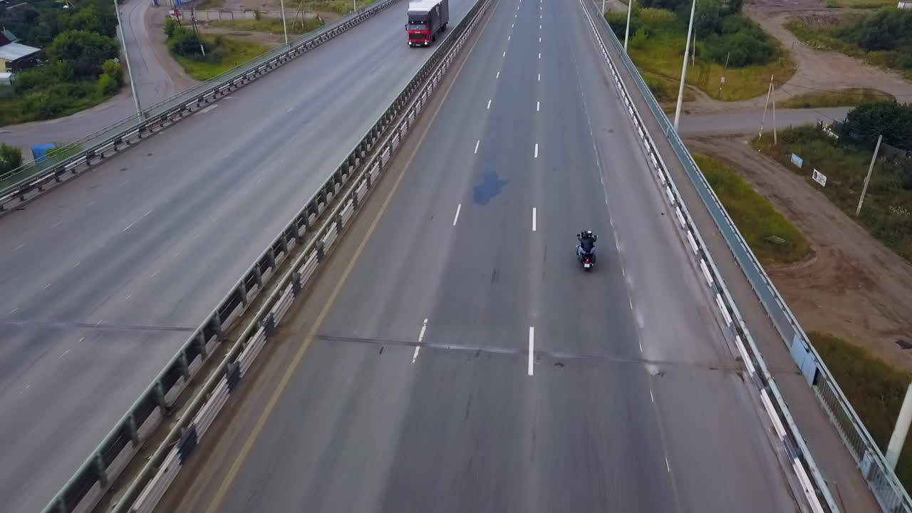Motorcycle and Trucks on Highway