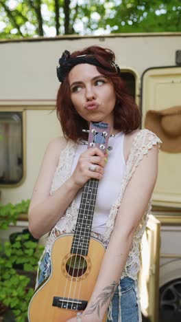 woman with ukulele near campervan