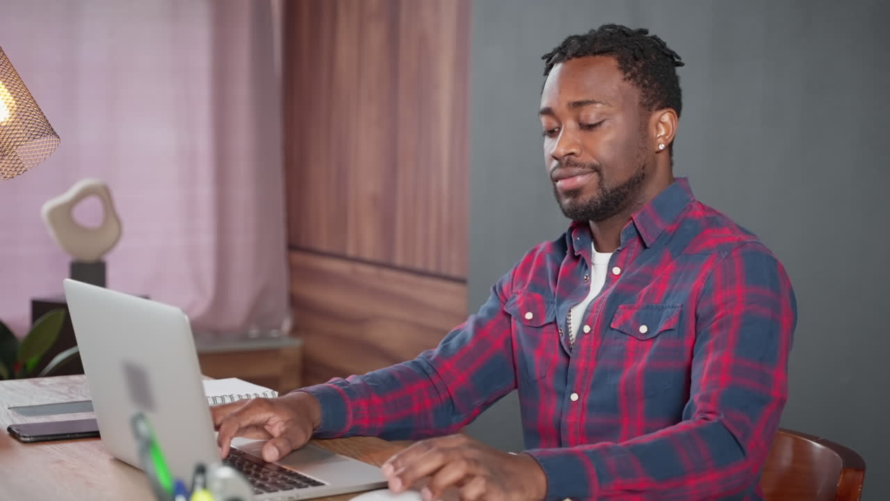 Man working on a laptop in a home office