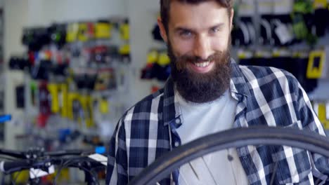 Mechanic-repairing-bicycle-in-workshop