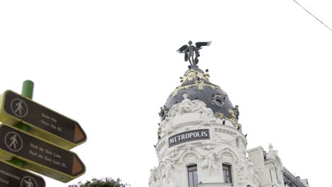 slow motion: madrid metropolis building and street signs