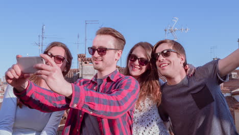 friends taking a selfie on a rooftop in venice