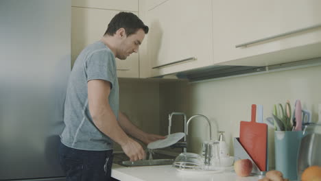 cheerful husband doing household chores in slow motion.