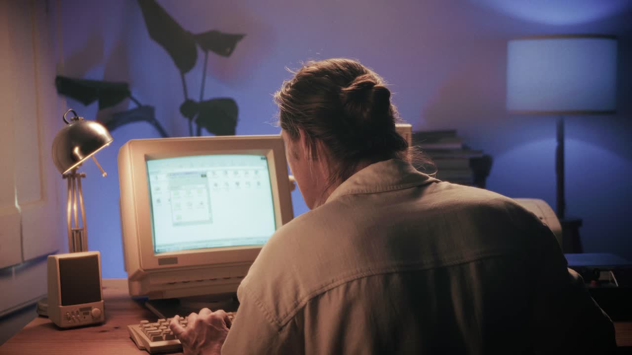 Man working and gaming on retro computer PC, IT engineer with vintage computer at home, using old fashion technology, close up of retro setup.