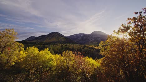 autumn scene with mountain peaks, yellow aspen forests and fall colors at sunset