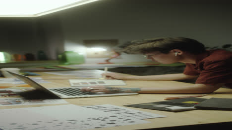 asian designer working on laptop at night
