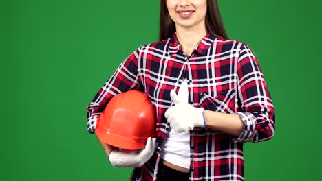 cropped shot of a smiling female engineer showing thimbs up holding hardhat