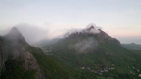 Misty-mountain-peaks-of-Peter-Both-in-Verdun,-Mauritius-at-dawn,-with-clouds-rolling-in