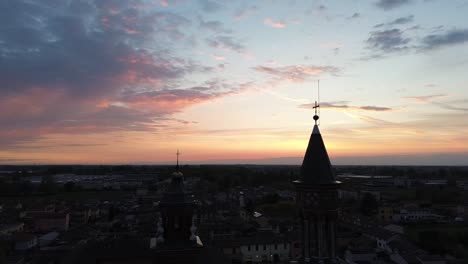 The-Sanctuary-of-Santa-Maria-della-Croce-in-Crema,-Italy,-is-seen-from-the-sky-with-a-sad-and-in-the-afternoon,-with-the-sun