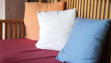 colorful pillows on a wooden bench