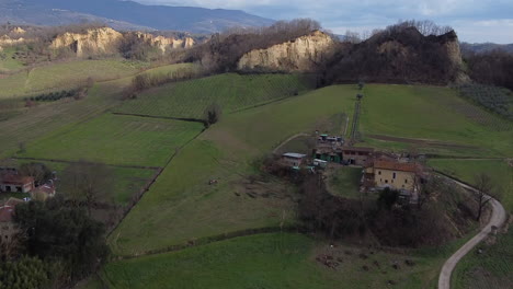 Approaching from the above Aerial flying drone shot over prehistoric age canyons Le Balze natural reserve near Reggello. Tuscany, Chianti area. Italy. Winter season, partially sunny sunset.