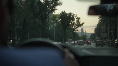 driving through a city street at sunset