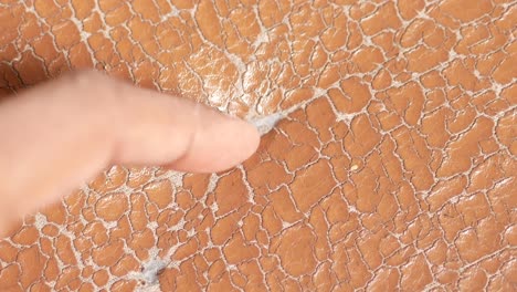 damaged leather with finger