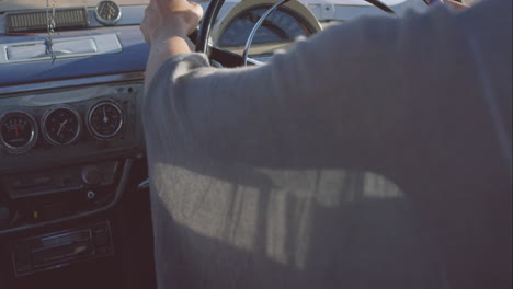 beautiful girl driving vintage car on road trip