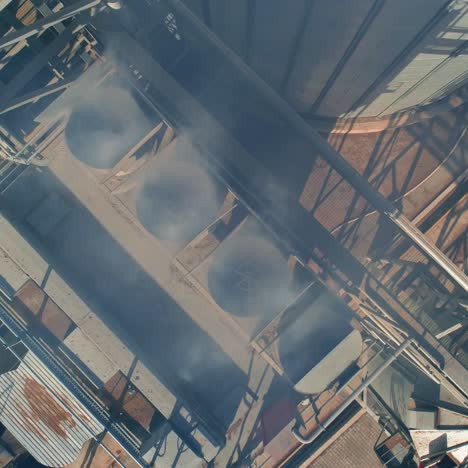 industrial metal air or smoke conditioning pipes from the roofs of an industrial factory. grain elevators from the top