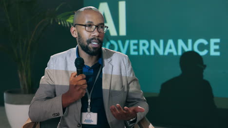 man speaking at an ai governance conference
