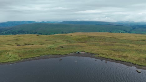 wild camping by a mountain lake on a cloudy day