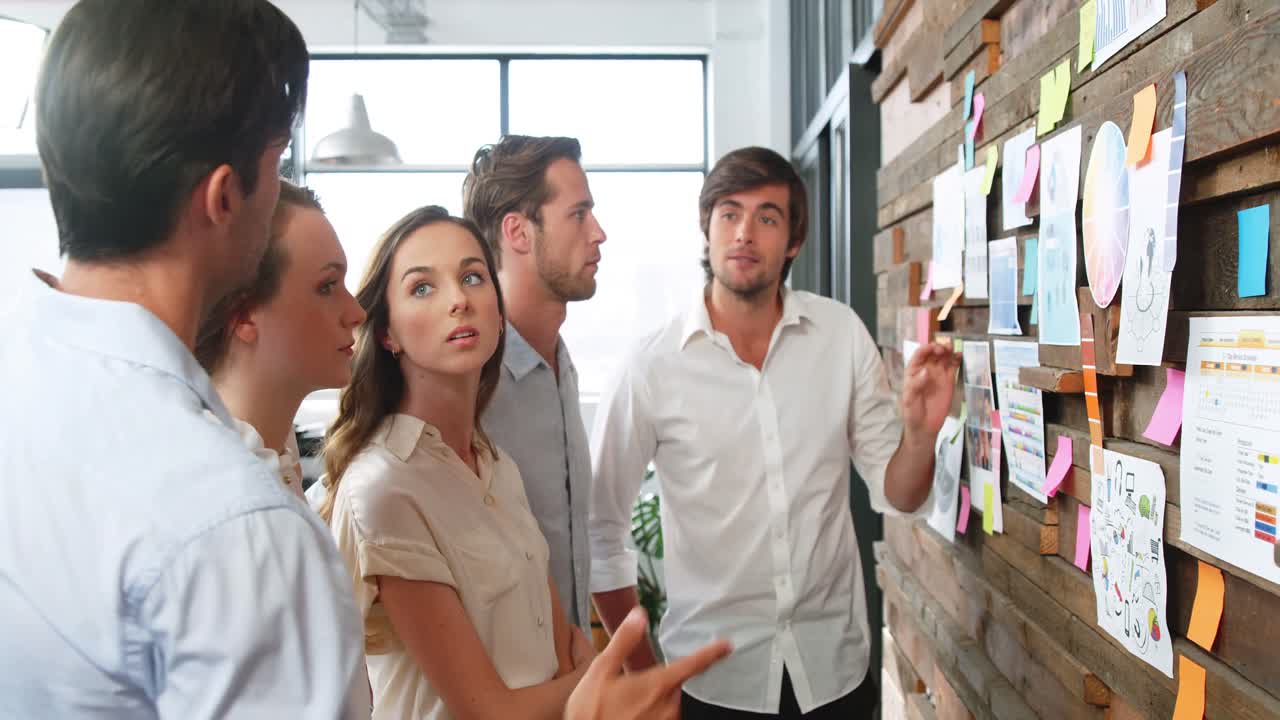ejecutivos de negocios discutiendo sobre notas adhesivas y gráficos