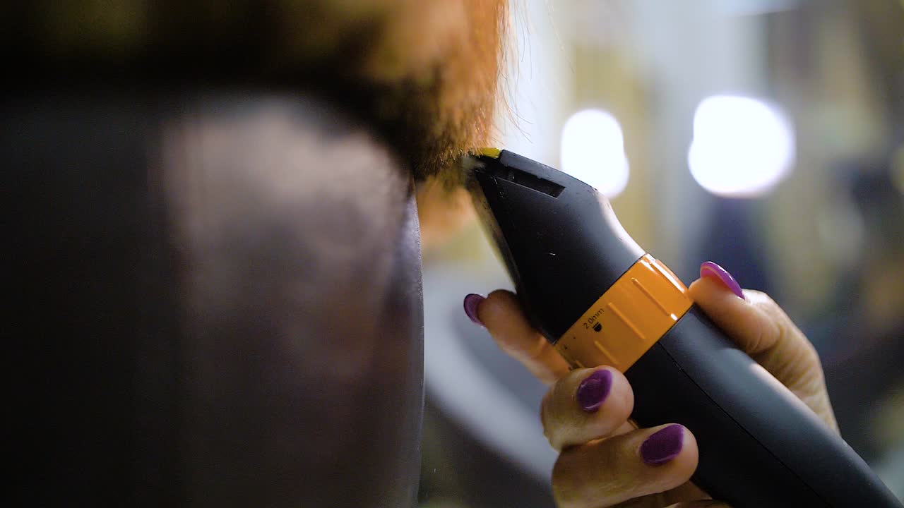 Slow motion of Hair clippers cutting women hair tips