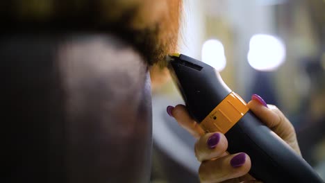 slow motion of hair clippers cutting women hair tips