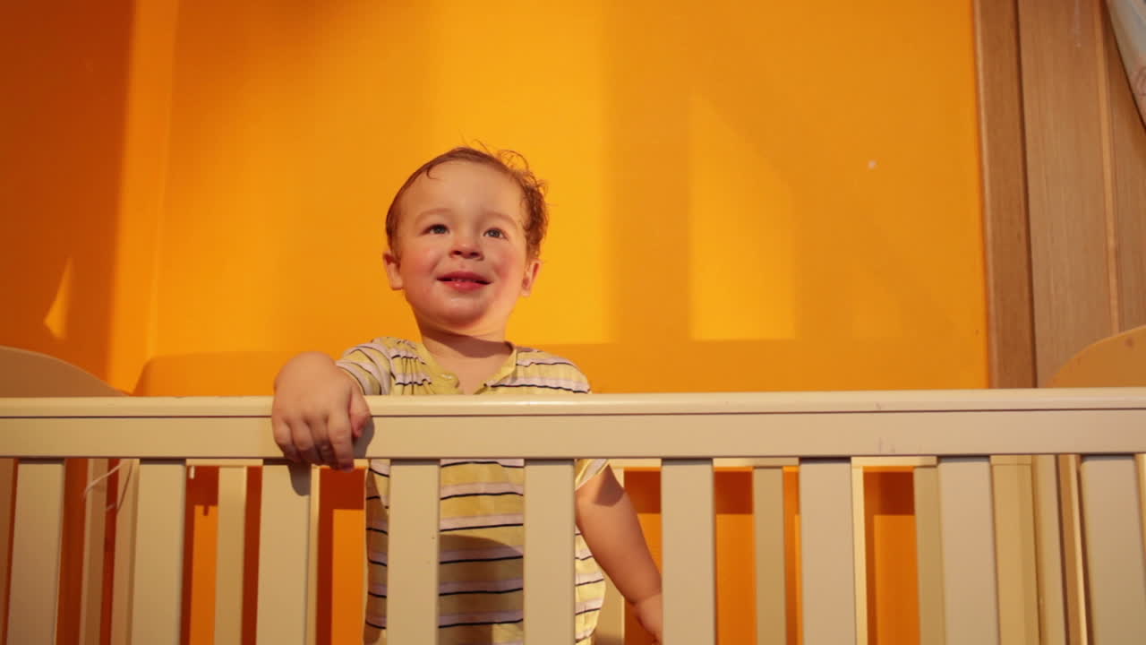Boy smiling in playpen