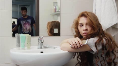 sad woman in bathroom, reflecting on an argument with her partner