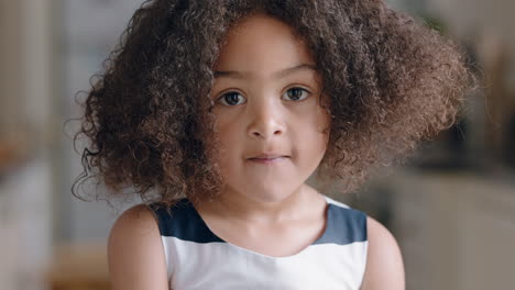 portrait-beautiful-little-mixed-race-girl-looking-at-camera-happy-child-at-home