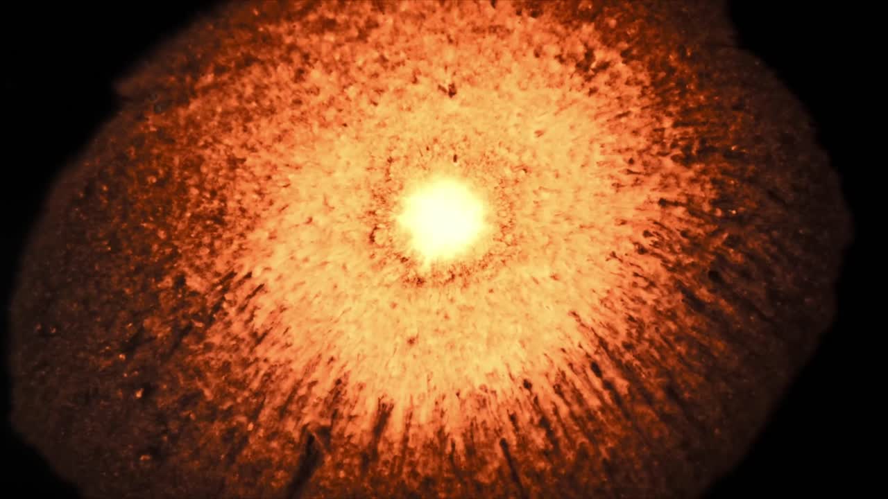 Abstract Glowing Orange Sphere Pulsating and Expanding in Darkness