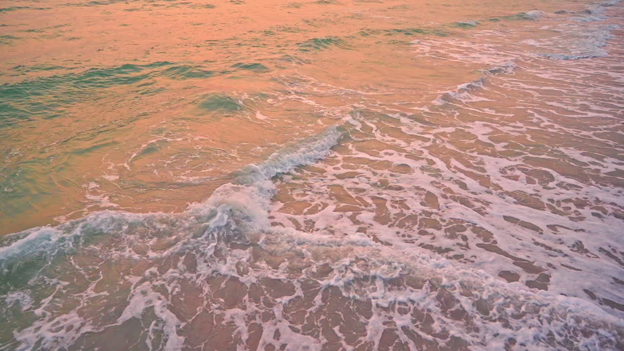 Orange Sunset Sunlight Reflecting in Waves Crashing at the Beach SLOMO