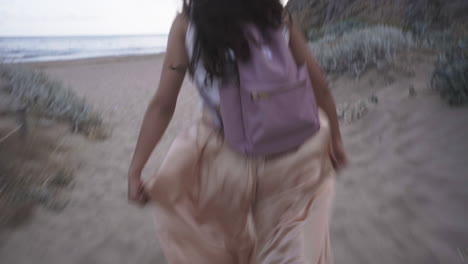 bubbly childlike latino woman exploring beach barcelona