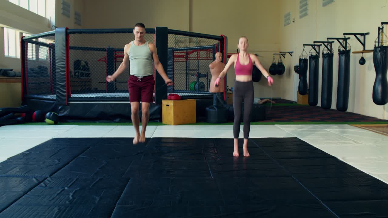 Man and Woman Skipping Rope in Gym