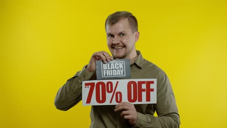 Shocked-amazed-store-client.-Man-showing-Black-Friday-and-Up-To-70-Percent-Off-inscriptions-signs