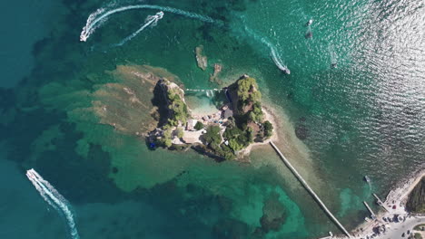 birds eye aerial view of cameo island, boats, beach and bridge connected to zakynthos, greece, high angle drone shot