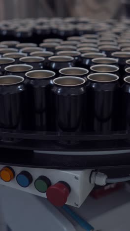 black aluminum cans on a production line