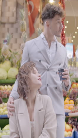 couple enjoying coffee at a fruit market